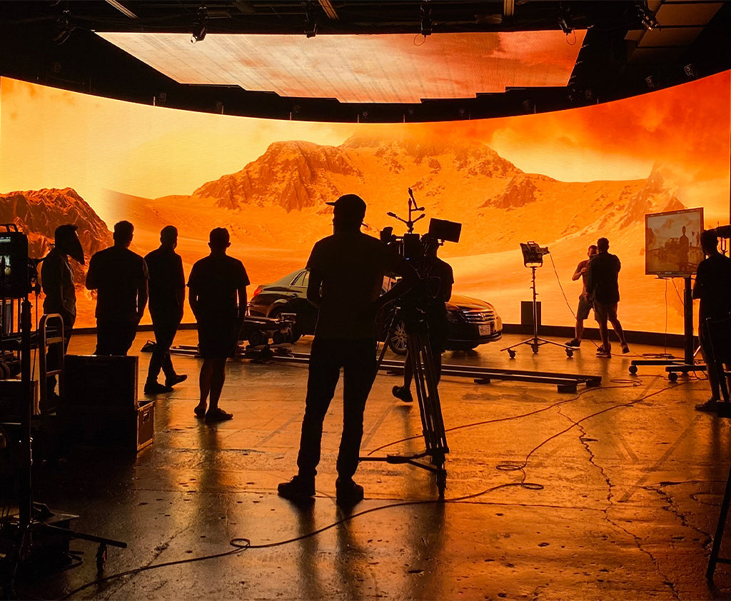 Virtual production team using VMX Visual LED display for immersive filming in an XR studio.